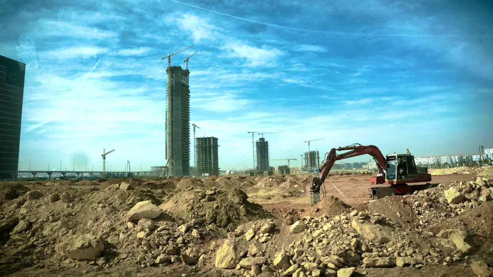 New Capital City_Picture gallery 1. Building site everywhere: excavators continue to work on the next prestigious project. In the background, the Central Business District is growing - with the Iconic Tower, Africa's tallest skyscraper.