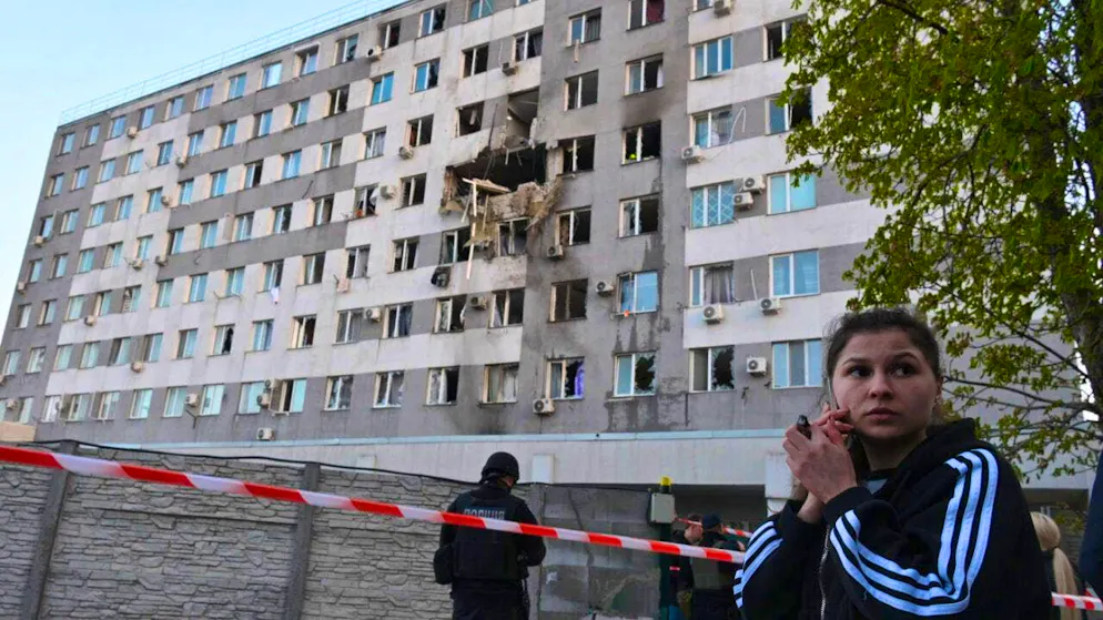 A woman talks on the phone in front of a residential building in Odessa that was damaged after a Russian drone attack. Photo: Michael Shtekel/AP/dpa