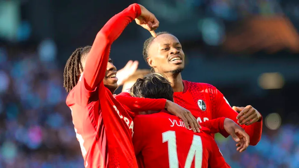 Johan Manzambi (right) celebrates with double goal scorer Yuito Suzuki (center)