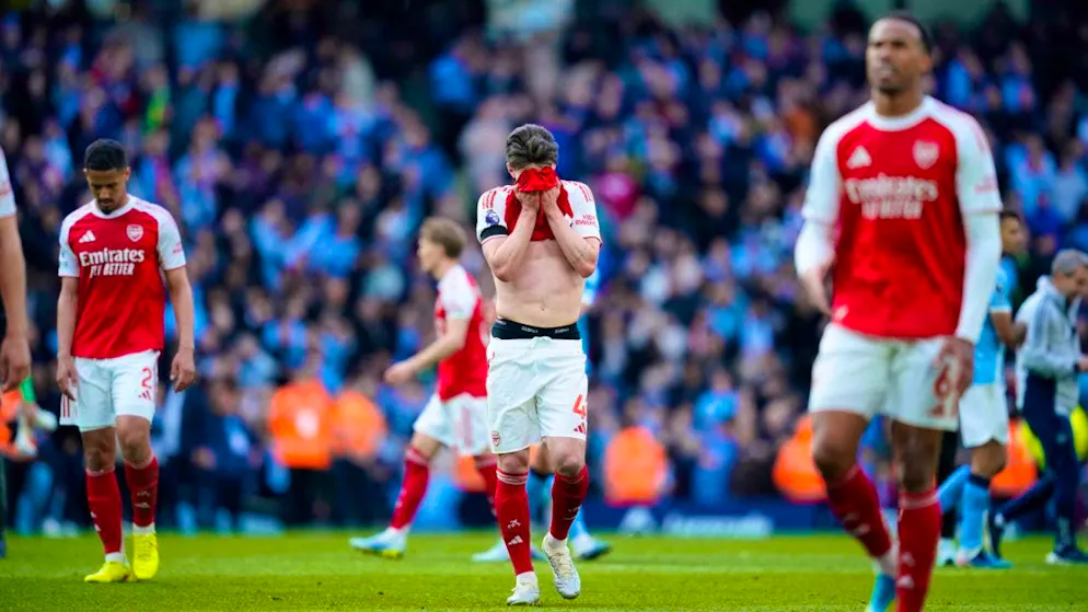 Still leaders show nerves: Arsenal's Declan Rice buries his face in his shirt after the defeat in Manchester
