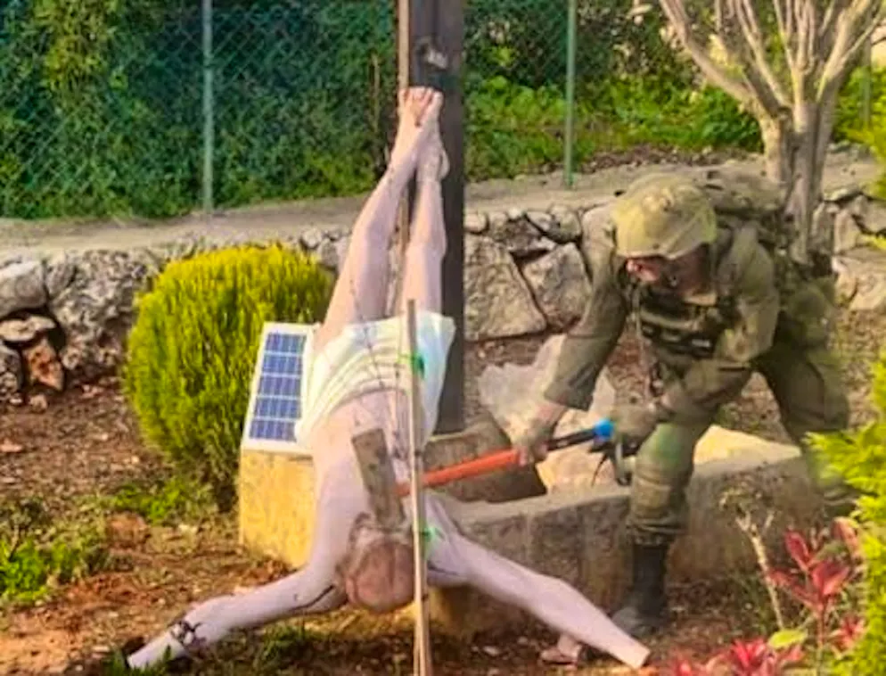 An Israeli soldier destroyed a figure of Jesus. 