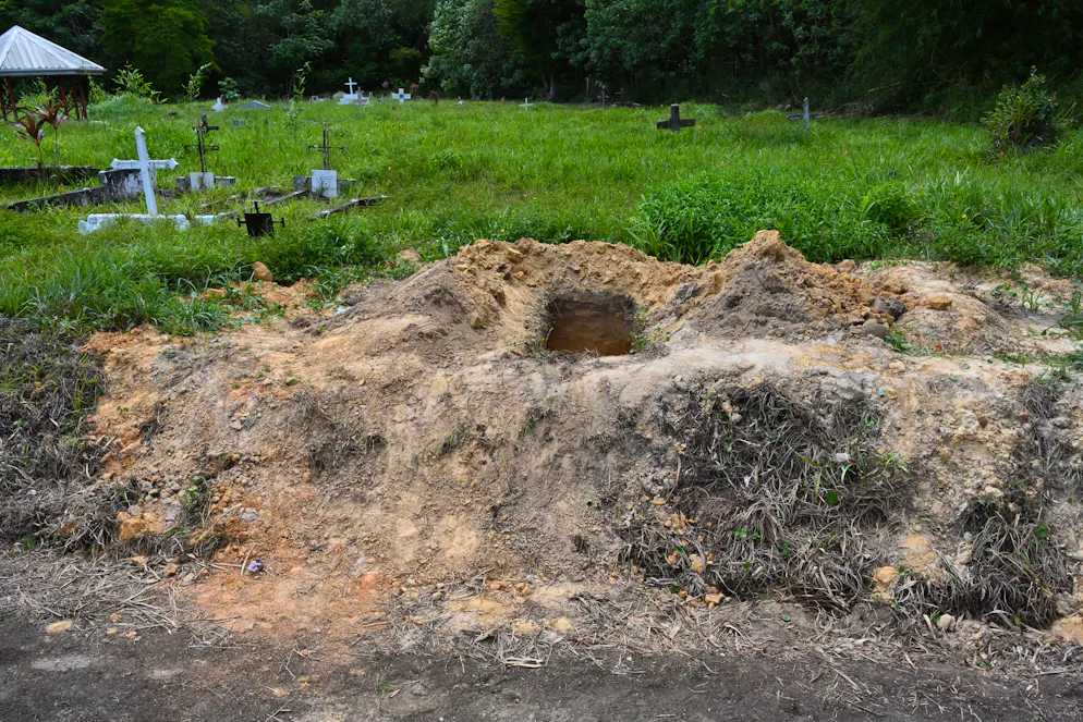Vue d'une tombe ouverte au cimetière de Cumuto, à Trinité-et-Tobago, prise le 18 avril 2026. Les restes d'au moins 50 nourrissons et de six adultes ont été découverts le 18 avril 2026, après avoir apparemment été abandonnés dans un cimetière de Trinité-et-Tobago, a indiqué la police. (Photo de Curtis Chase / AFP)