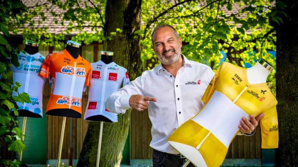 Race director Richard Chassot poses here with the jerseys for the 79th edition of the Tour de Romandie