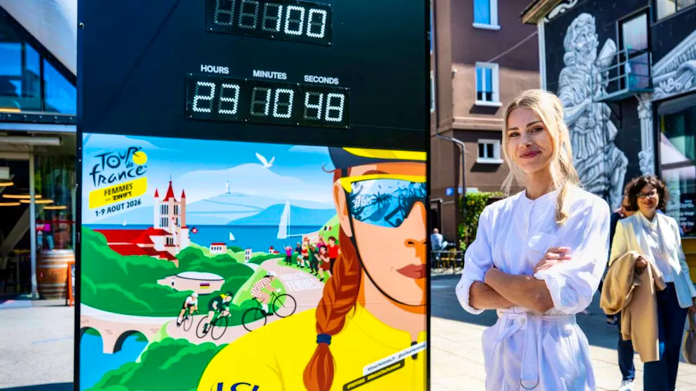 Marion Rousse, Director of the Tour de France Femmes, stands next to the sign for the 2026 edition with the countdown in Lausanne