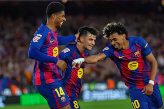 Barcelona's Marcus Rashford, left, celebrates after scoring his side's fourth goal with Lamine Yamal, right, and Pedri during the Spanish La Liga soccer match between Barcelona and Espanyol in Barcelona, Spain, Saturday, April 11, 2026. (AP Photo/Joan Monfort)