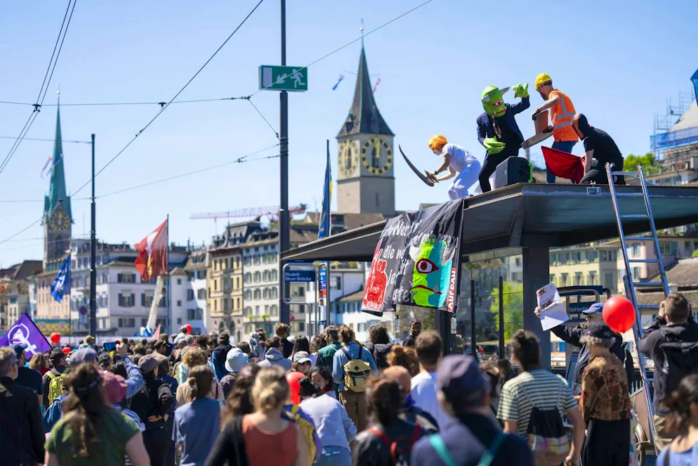 May 1, 2026. Participants demonstrate at the traditional May Day procession. Some climbed onto the roof of a streetcar stop.