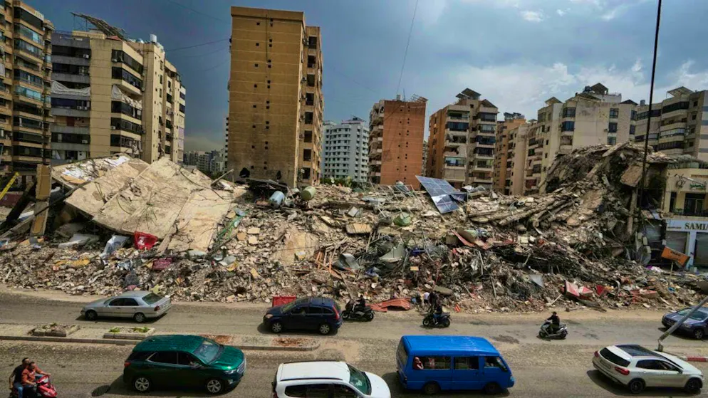 ARCHIVE - Residents drive past the rubble of destroyed buildings in Dahija, a southern suburb of Beirut, Lebanon. After weeks of fighting between Israel and the Lebanese Hezbollah militia, a ceasefire has officially come into force. Photo: Bilal Hussein/AP/dpa