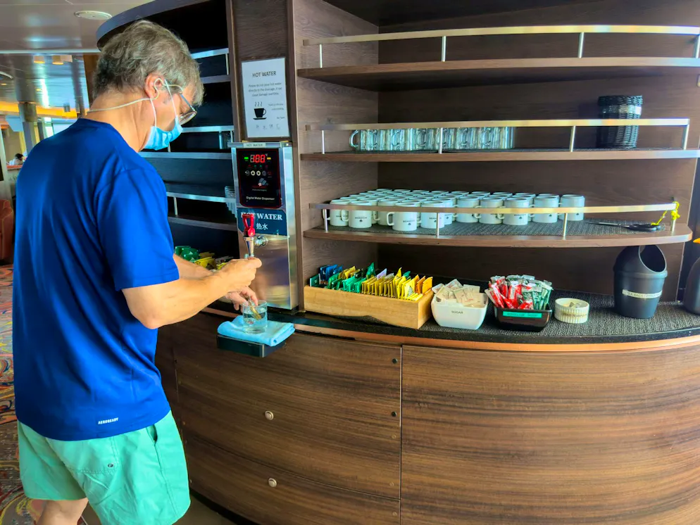 A passenger on the cruise ship affected by the hantavirus helps himself to water during the journey to Tenerife.