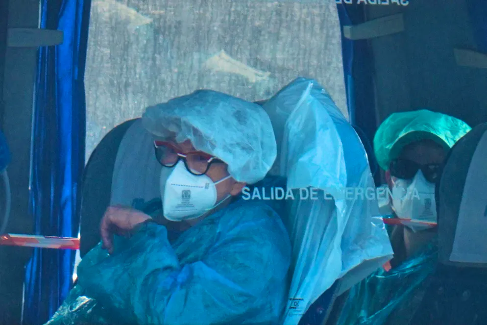 The evacuated people were wearing protective suits and masks.