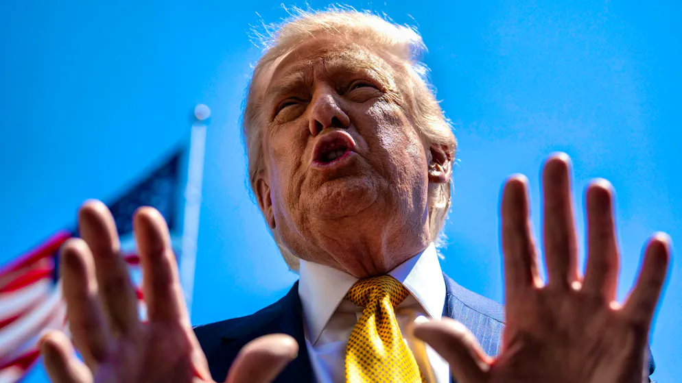 US President Donald Trump speaks to journalists on Tuesday before leaving for Beijing.