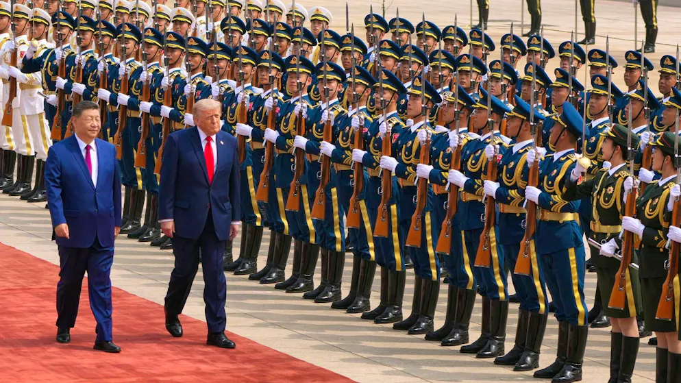 Xi Jinping and Donald Trump walk past the honor guard in Beijing today.