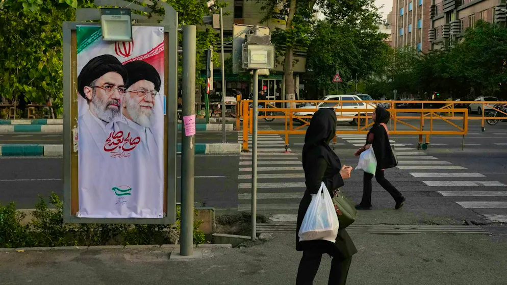 A banner with portraits of Iran's supreme leader Moshtaba Khamenei and his father Ayatollah Ali Khamenei, who was killed in US and Israeli airstrikes. (May 12, 2026)