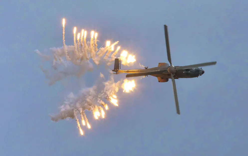 A Swiss Air Force Cougar AS532 helicopter with the identification T-340 during a flare mission on the Axalp in Bern.