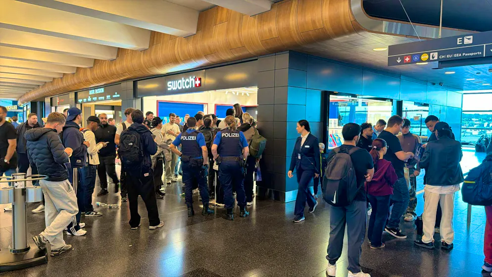 Swatch. Fans queue up at Zurich Airport for the new Swatch special watch.