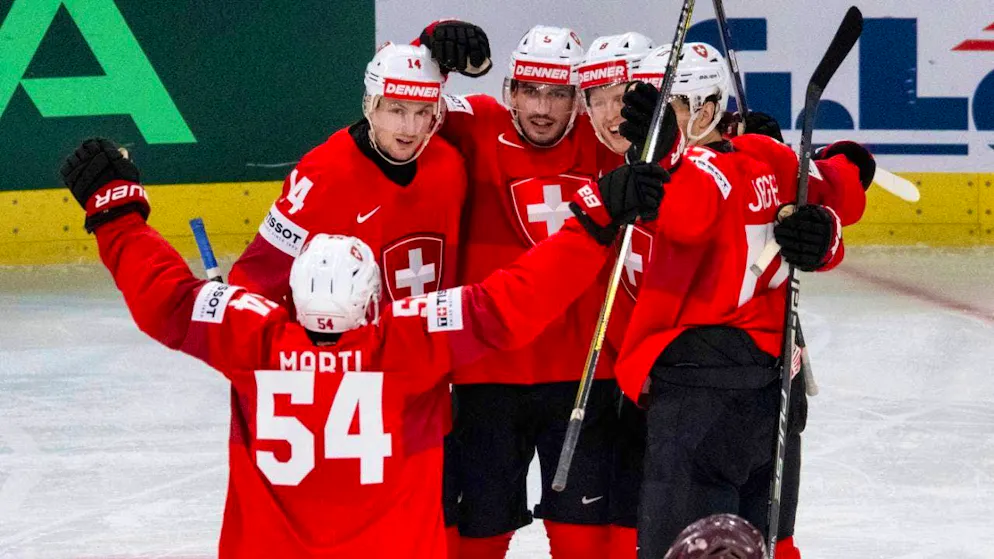 Swiss two-goal shooter Damien Riat (center) celebrates with his teammate