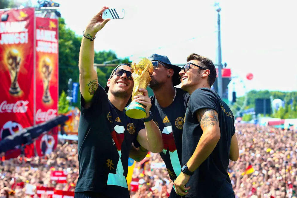Lukas Podolski (left) is celebrated by the Germany fans after the 2014 World Cup triumph.