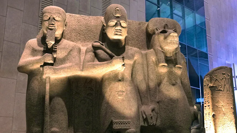 Ramses II between Ptah, the god of creation and craftsmanship, and the lion goddess Sekhmet, goddess of war and healing.