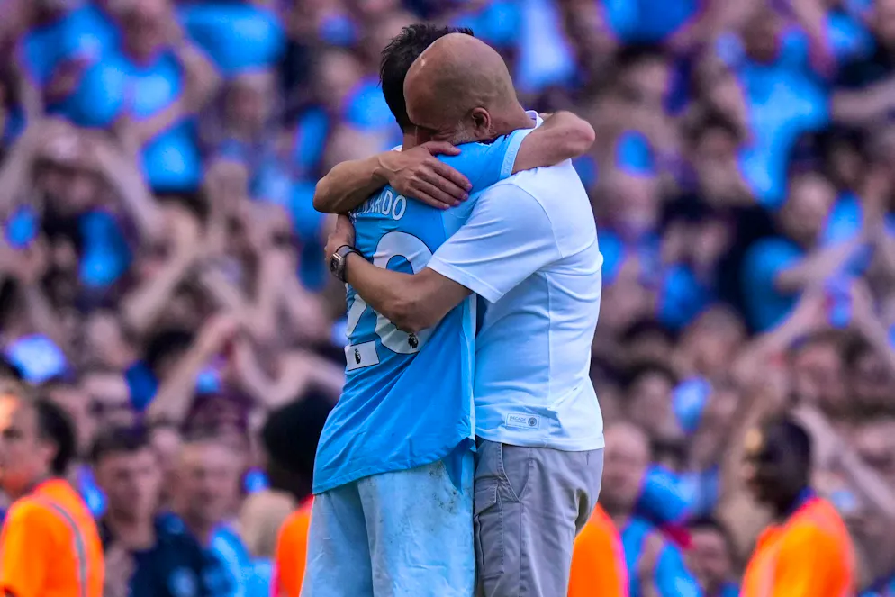 Premier League: Tottenham save themselves, West Ham relegated - Gallery. Manchester City coach Pep Guardiola (r) hugs Bernardo Silva. It was the last City game for both players.