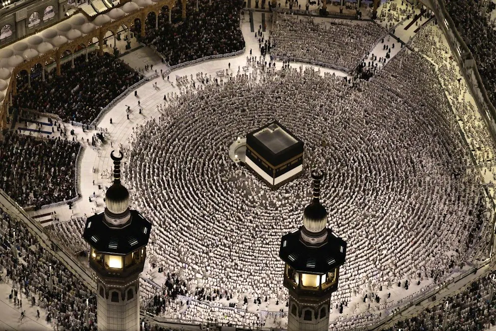 This aerial view shows the Grand Mosque complex in Mecca, as Muslims perform the evening prayer around the Kaaba, Islam's holiest shrine, on May 24, 2026, ahead of the annual Hajj pilgrimage. Over 1.5 million pilgrims have arrived in Saudi Arabia from outside the kingdom for the upcoming hajj, according to a Saudi official, exceeding the number of international visitors last year despite the war in the Middle East. (Photo by Zain JAAFAR / AFP)
