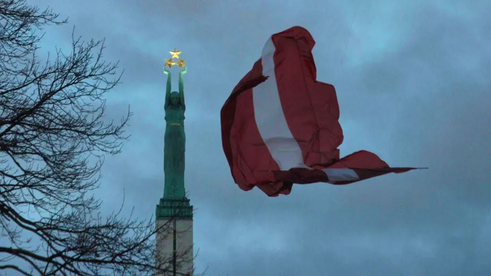 ARCHIVE - A Latvian flag flies at the Freedom Monument. Photo: Alexander Welscher/dpa