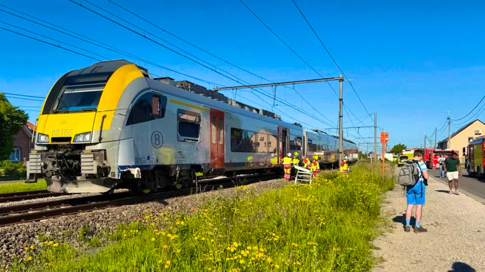 Rescue workers are at the scene of an accident after a train collided with a school bus at the Vierhuizen level crossing in Buggenhout. Photo: Koen Baten/AP/dpa