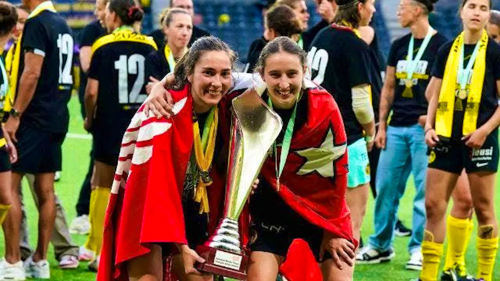 Malaurie Granges (right) poses with the trophy.
