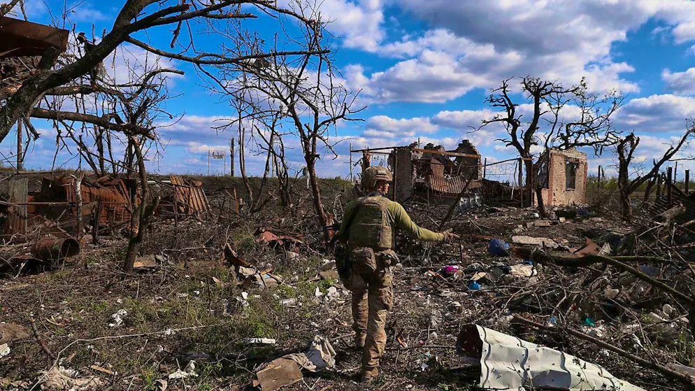 A Ukrainian soldier points to a destroyed house on the front line. The brigade announced that it had recaptured the war-ravaged settlement located 10 kilometers south of the Russian-occupied town of Bakhmut in the embattled east of the country.