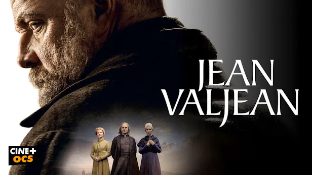 Une affiche au format paysage sur fond sombre. Sur la gauche, le visage de profil d'un homme mûr, barbu et sérieux (Dominic West en Jean Valjean) apparaît en gros plan. En bas au centre, une incrustation plus petite montre trois personnages debout (une jeune femme, un homme en manteau sombre et une femme plus âgée) sous un ciel nuageux. Sur la droite, le titre 