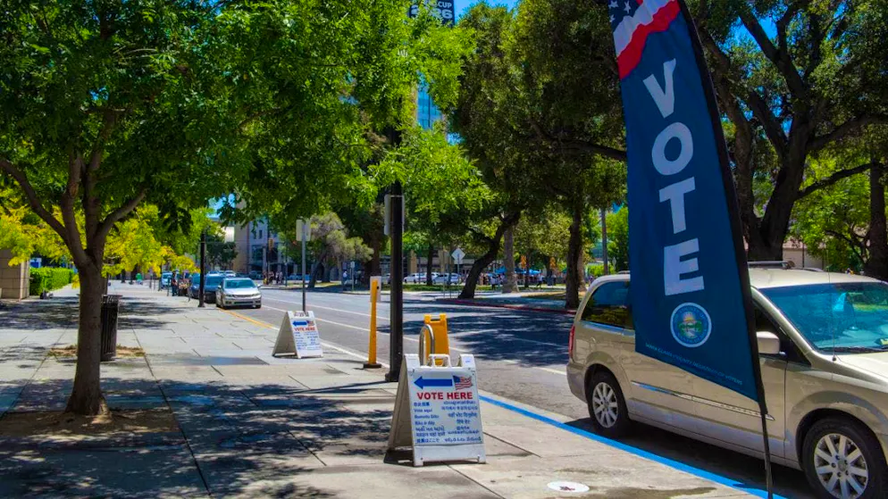 Signs are seen outside a polling station for the primary election to elect a new governor of California. Photo: Andrej Sokolow/dpa