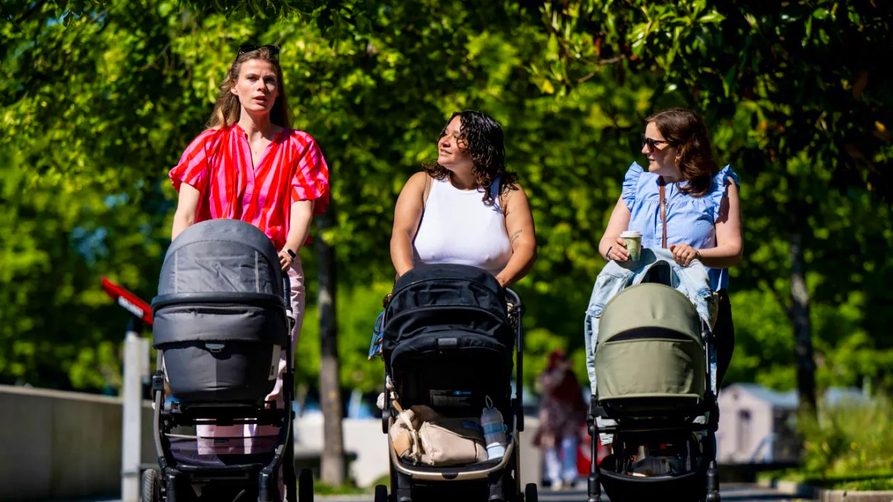 Society. Mothers walk against loneliness with baby carriages on the 